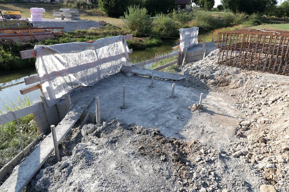 Frisch betoniertes Fundament mit vorbereiteter Bewehrung